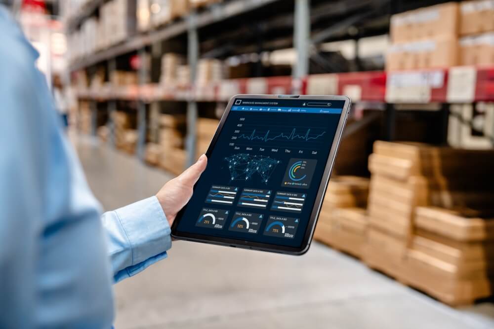 Businessman using digital tablet with warehouse management system sp.jpg